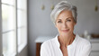 © Concept Island - Beautiful mature woman in her 50s with short gray hair and perfect skin in a modern bathroom
