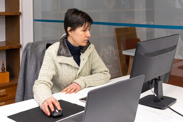 A woman working in office in front of computer