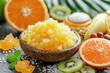 Herbal therapeutic body scrub with sea salt in bowl  with citrus fruits
