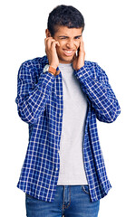 Poster - Young african amercian man wearing casual clothes covering ears with fingers with annoyed expression for the noise of loud music. deaf concept.