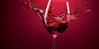 Splashing red wine in a wine glass imitation close up on red background