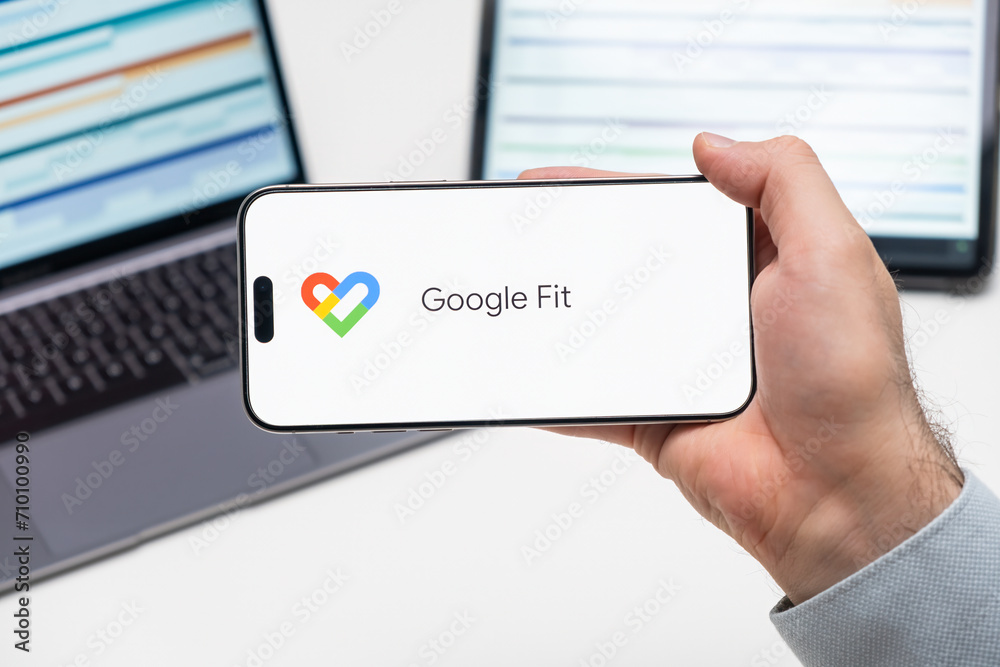 Google Fit Interface Google Fit logo of app on the screen of mobile phone held by man in ...