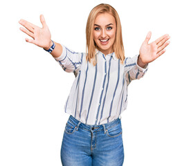 Wall Mural - Beautiful caucasian woman wearing casual clothes looking at the camera smiling with open arms for hug. cheerful expression embracing happiness.