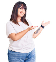 Sticker - Young plus size woman wearing casual clothes inviting to enter smiling natural with open hand