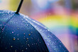 canvas print picture - Farbenfroher Schutz im Regen: Ein Regenschirm vor einem Regenbogen, eine magische Szene, die den Schutz vor Nässe mit einem Hauch von Farbenpracht vereint.