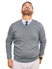 Wall Mural - Handsome middle age man wearing business clothes angry and mad screaming frustrated and furious, shouting with anger. rage and aggressive concept.