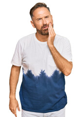 Sticker - Handsome middle age man wearing casual tie dye tshirt touching mouth with hand with painful expression because of toothache or dental illness on teeth. dentist