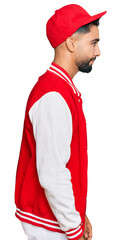 Poster - Young man with beard wearing baseball uniform looking to side, relax profile pose with natural face with confident smile.