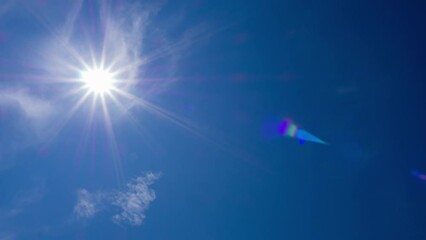 Wall Mural - beautiful bright sunstar in midday clear blue sky in winter season. burning sun wispy clouds surroun