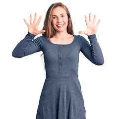 Canvas Print - Young beautiful blonde woman wearing casual dress showing and pointing up with fingers number ten while smiling confident and happy.