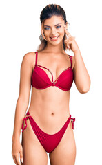 Poster - Young beautiful woman wearing bikini smiling pointing to head with one finger, great idea or thought, good memory