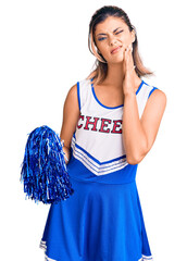 Sticker - Young beautiful woman wearing cheerleader uniform touching mouth with hand with painful expression because of toothache or dental illness on teeth. dentist concept.