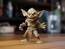 3d Printed Scary Laughing Plastic Goblin Figurine Standing On A Wooden Table