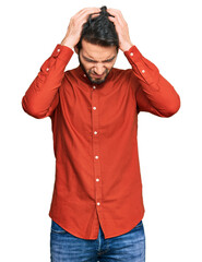 Poster - Young hispanic man wearing casual clothes suffering from headache desperate and stressed because pain and migraine. hands on head.