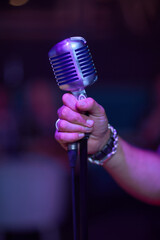 Wall Mural - Retro microphone on stage in a pub or American Bar restaurant during a night show.