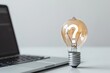 Light bulb with question mark sign and laptop on white background, curiosity, ideas and technology concept.