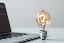 Light Bulb With Question Mark Sign And Laptop On White Background, Curiosity, Ideas And Technology Concept.
