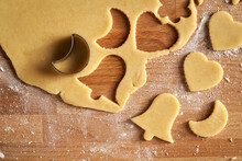 Cutting Out Star And Bell Shapes From Pastry Dough To Prepare Linzer Christmas Cookies
