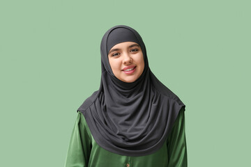 Sticker - Happy young Muslim woman in hijab on green background