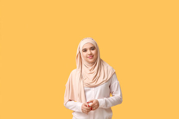 Sticker - Beautiful young Muslim woman in hijab on yellow background