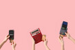 Women with credit cards, payment terminals and calculator on pink background