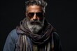 Portrait of a handsome bearded man with sunglasses and a scarf. Men's beauty, fashion.
