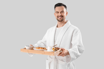 Sticker - Young man with tasty breakfast on light background. Valentine's Day celebration