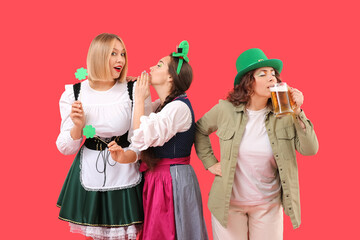 Poster - Women in costumes celebrating St. Patrick's Day on red background