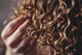 Fototapeta  - Woman using curly hair method for styling.