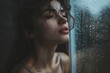 A contemplative woman gazes out of a fogged window, her wet hair clinging to her face as she is lost in thought amidst the gentle bubbles of water