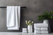 White towels in proximity to a gray wall