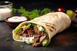 Shawarma Beef sandwich with grilled meat salad and white sauce on a lavash