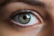 Close up of a beautiful woman s tired green eye with contact lenses Dry eye relief demonstrated using eye drops