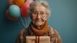 Attractive mature aged aged woman holding presents gift box feels happy studio