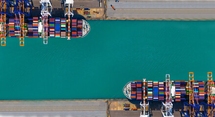 Global transportation and logistic business. Aerial top view over international containers cargo ship at industrial import-export port prepare to load containers with big container loader ship vessel.