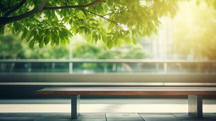 blurred abstract background of bench under tree in green at modern eco office building in sunny day