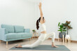 © Shisu_ka - Slim woman practicing yoga on room of her condo or home. Asian woman doing exercises in morning. balance, meditation, relaxation, calm, good health, happy, relax, healthy lifestyle, diet, slim