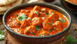 A close-up of butter chicken masala garnished with cilantro in a bowl, AI generated
