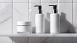 © Daria Lukoiko - Skincare cosmetics on a shelf in a white bathroom. Cream jar container for shower gel, soap, shampoo without labels or brands. Body care, hygiene and spa concept