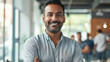 © Farnaces - Portrait of a handsome smiling asian indian businessman boss standing in his modern business company office.