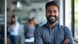 © Farnaces - Portrait of a handsome smiling asian indian businessman boss standing in his modern business company office.