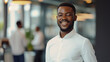© Farnaces - Portrait of a handsome smiling black businessman boss standing in his modern business company office.