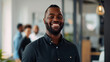 © Farnaces - Portrait of a handsome smiling black businessman boss standing in his modern business company office.