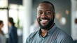 © Farnaces - Portrait of a handsome smiling black businessman boss standing in his modern business company office.