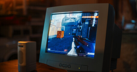 Poster - Close Up Of Old Desktop Computer With 3D First-Person Shooter Video Game In Retro Garage Late At Night In Nineties. Dated PC Of Gamer Running Popular Game With Character Playing Against Enemies.