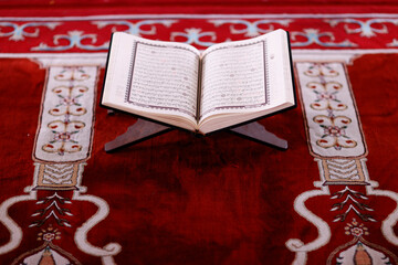 Poster - Mubarak mosque. Open Quran in arabic on wood stand. Symbol of Islam. Vietnam.