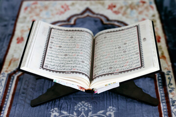 Poster - Mubarak mosque. Open Quran in arabic on wood stand. Symbol of Islam. Vietnam.