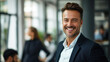 © Farnaces - Portrait of a handsome smiling businessman boss standing in his modern business company office.