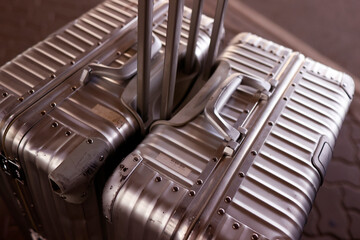 Poster - Silver metal suitcases at airport.  Vacation  and travil concept.