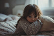 © toonsteb - young girl kid sitting on bed with sad expression